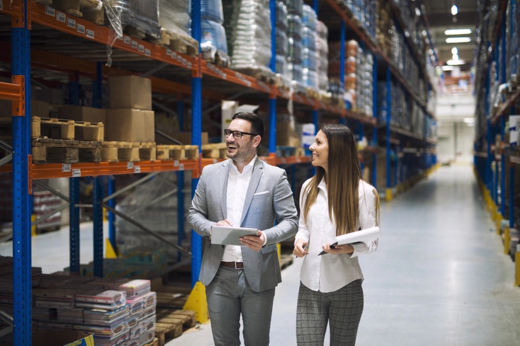 Wholesale business owners reviewing warehouse operations